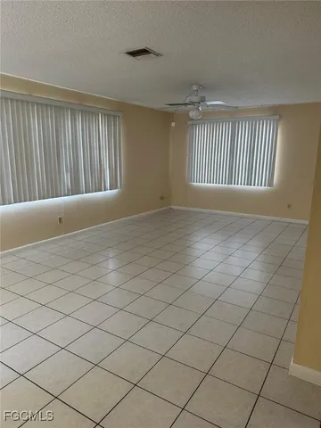 a view of an empty room and a window