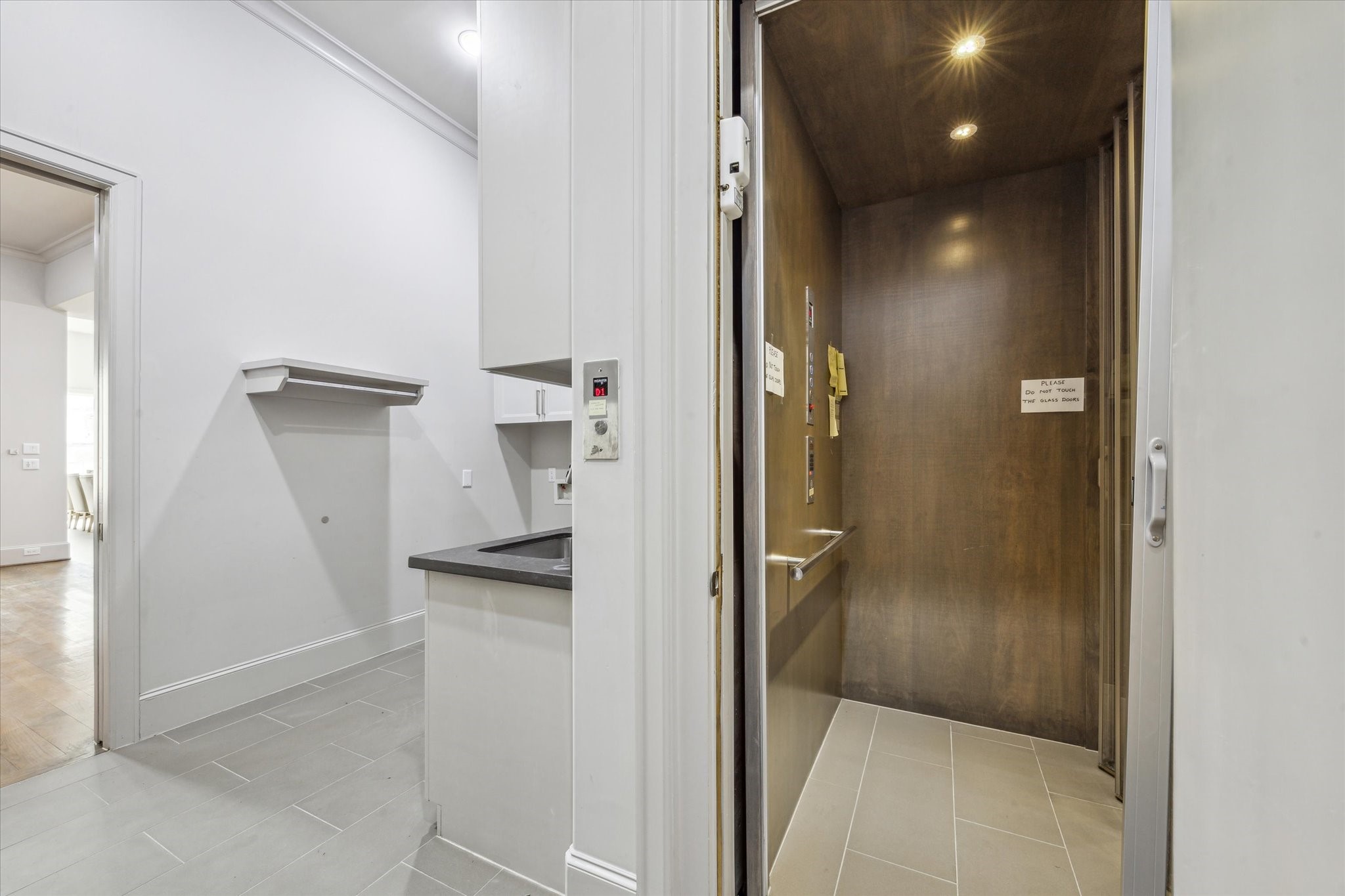 4615 Verone Street Bellaire, TX 77401 - Photo 20 of 43 ELEVATOR: Convenience meets luxury with the elevator that seamlessly travels from the garage to the first and second floors. Offering effortless access to all levels of the home, this sophisticated feature ensures ultimate ease of movement, whether you're bringing in groceries, moving between floors, or simply enjoying the added comfort.