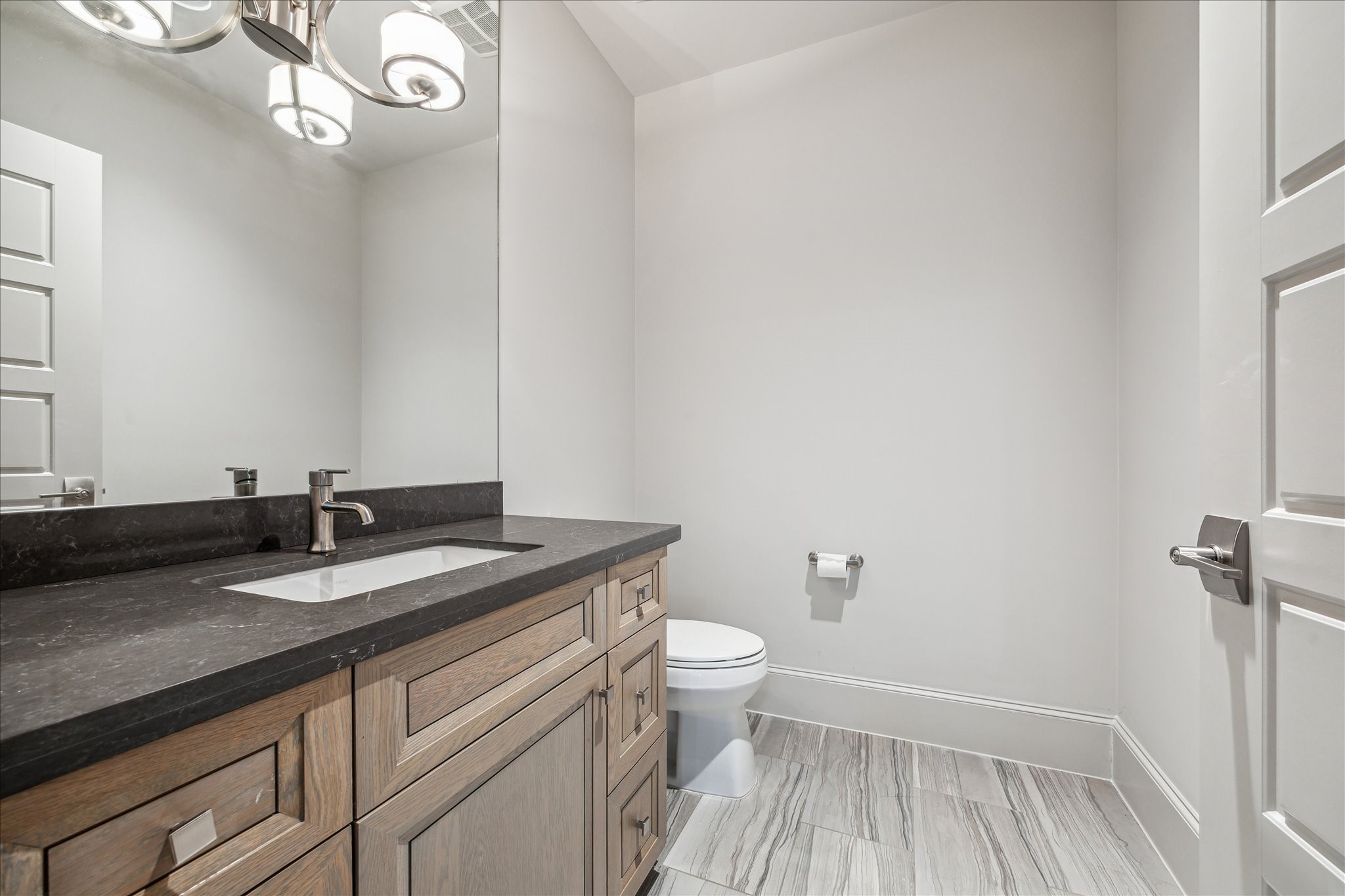 4615 Verone Street Bellaire, TX 77401 - Photo 28 of 43 Powder Room on the 2nd floor: Conveniently located for guests, this stylish second-floor powder bath offers easy access from the game room, media room, and gym.