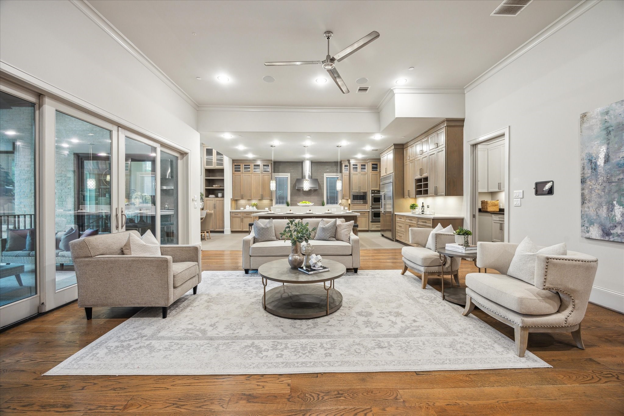 4615 Verone Street Bellaire, TX 77401 - Photo 5 of 43 This breathtaking family room is designed to embrace the beauty of indoor-outdoor living. Expansive windows frame stunning views of the veranda, seamlessly blending the outdoors with the elegant interior.