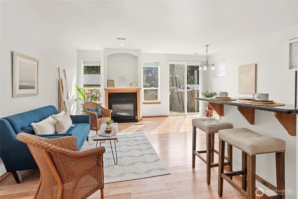 a living room with furniture a large window and a fireplace