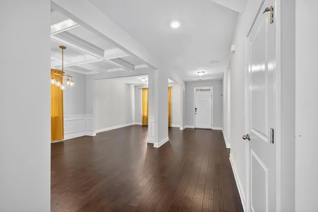 a large kitchen with granite countertop a large counter top appliances and cabinets