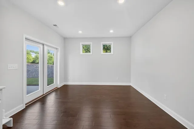 a kitchen with granite countertop white cabinets and stainless steel appliances