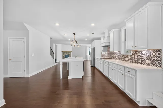 a view of an empty room with window and fireplace