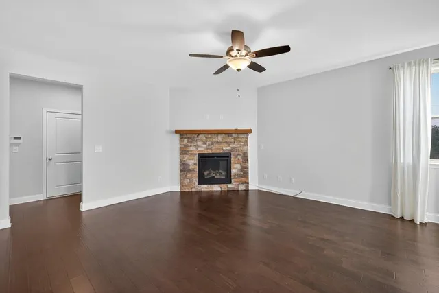 a view of a livingroom with a ceiling fan and window