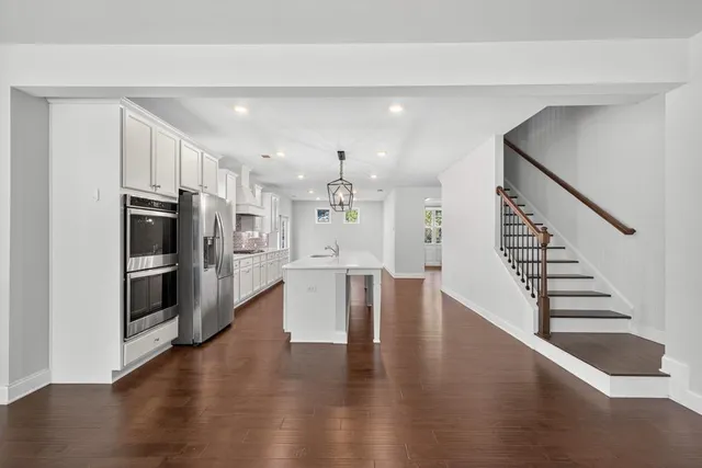 a view of a kitchen with a sink a window and stainless steel appliances