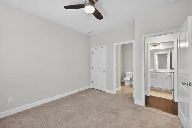 a view of a hallway with wooden floor and stairs