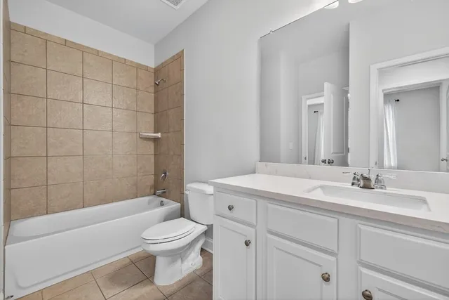 an empty room with closet and windows