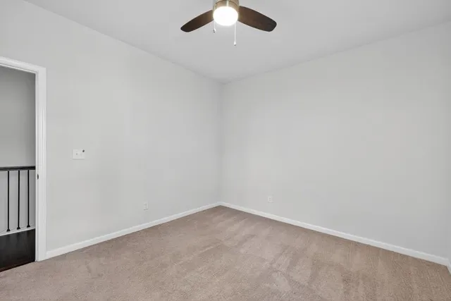 a view of a big room with closet and windows