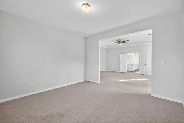 a spacious bathroom with double vanity and a mirror