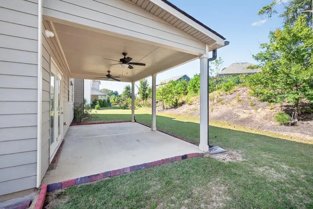 a view of a hallway with wooden floor and windows