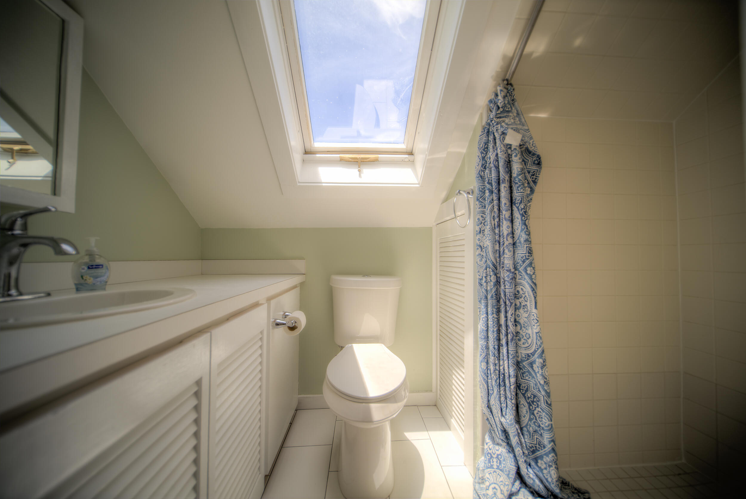1317 Newton Street Key West, FL 33040 - Photo 16 of 19 a bathroom with a sink a toilet and shower curtain
