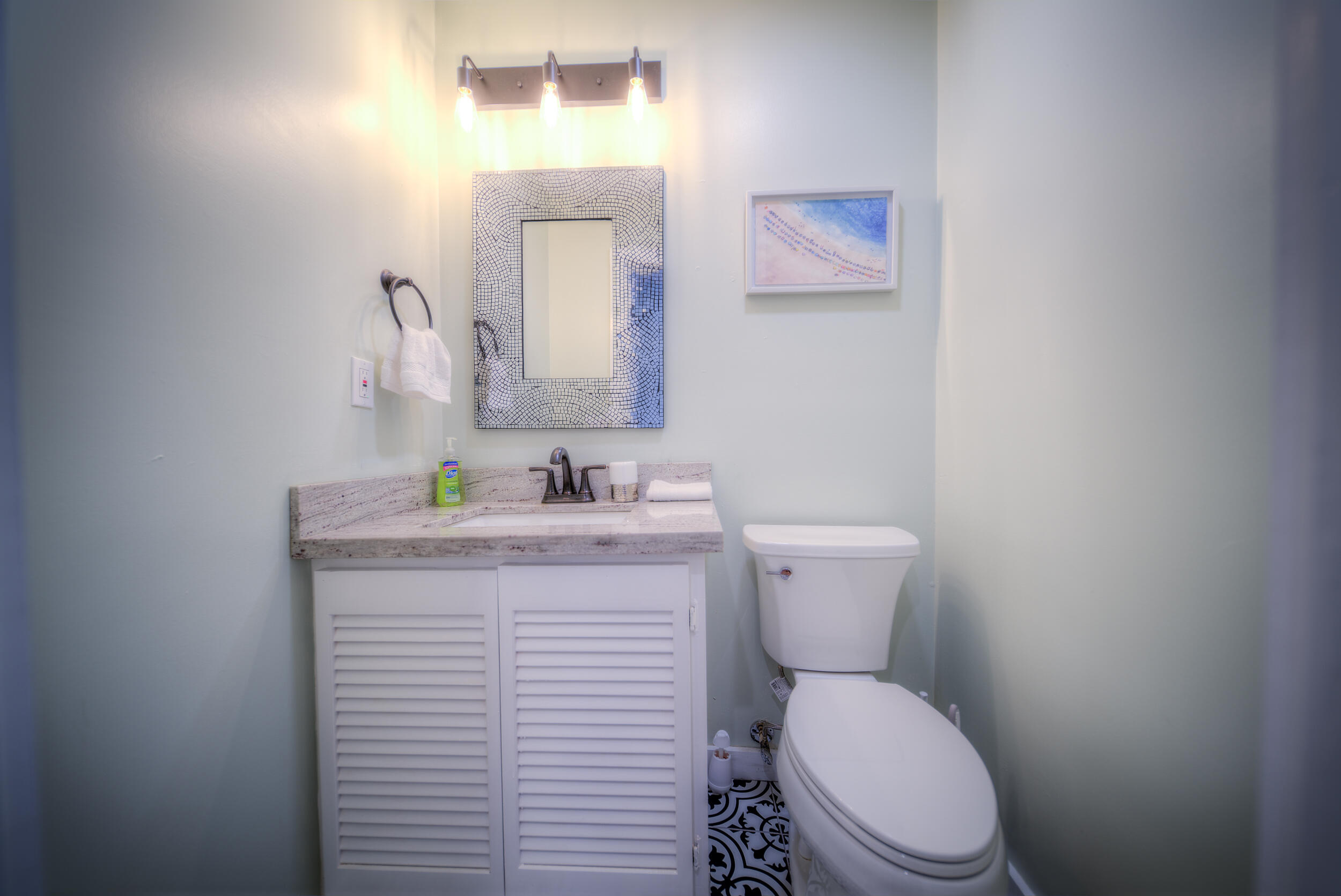 1317 Newton Street Key West, FL 33040 - Photo 17 of 19 a bathroom with a toilet sink and mirror