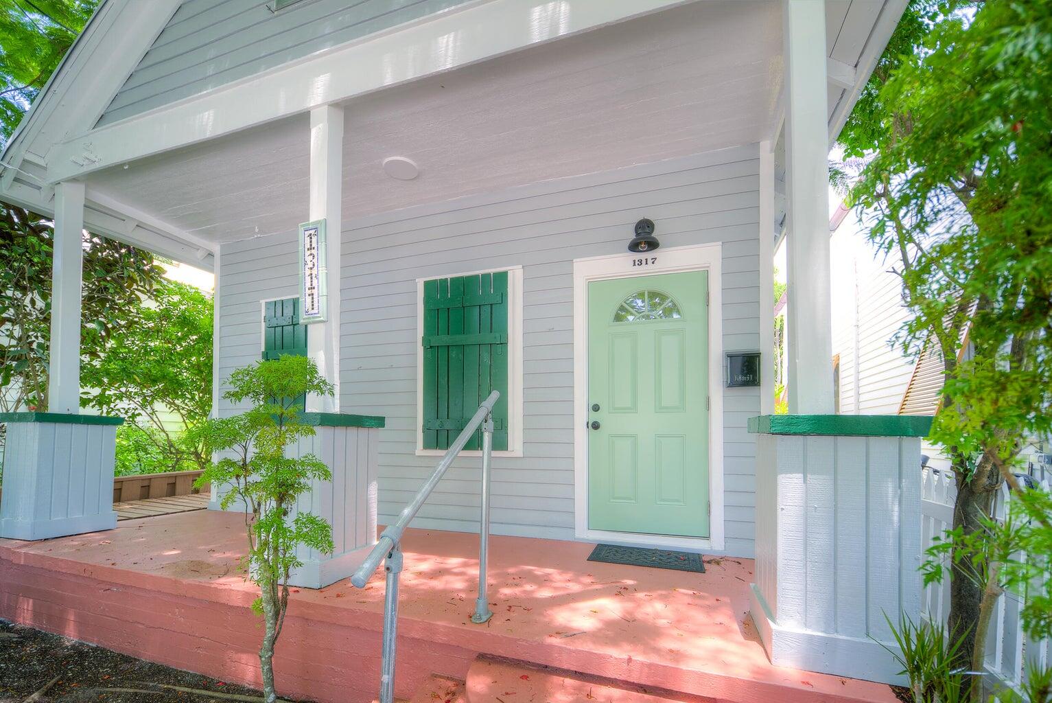 1317 Newton Street Key West, FL 33040 - Photo 2 of 19 a front view of a house with a garden
