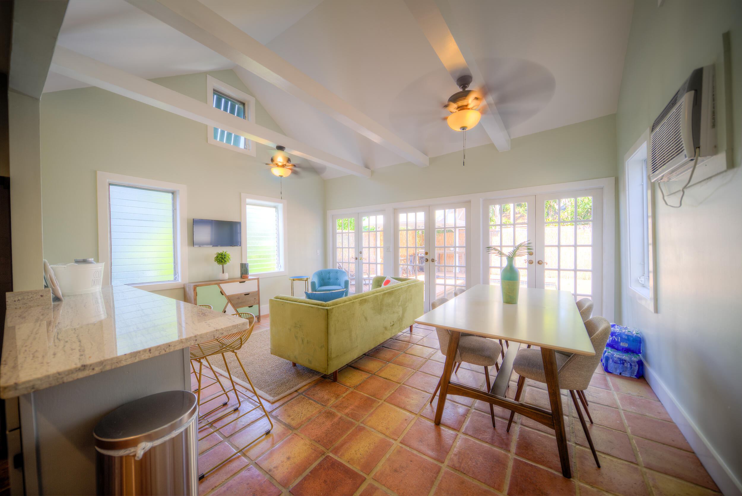 1317 Newton Street Key West, FL 33040 - Photo 4 of 19 a living room with furniture a chandelier and a dining table