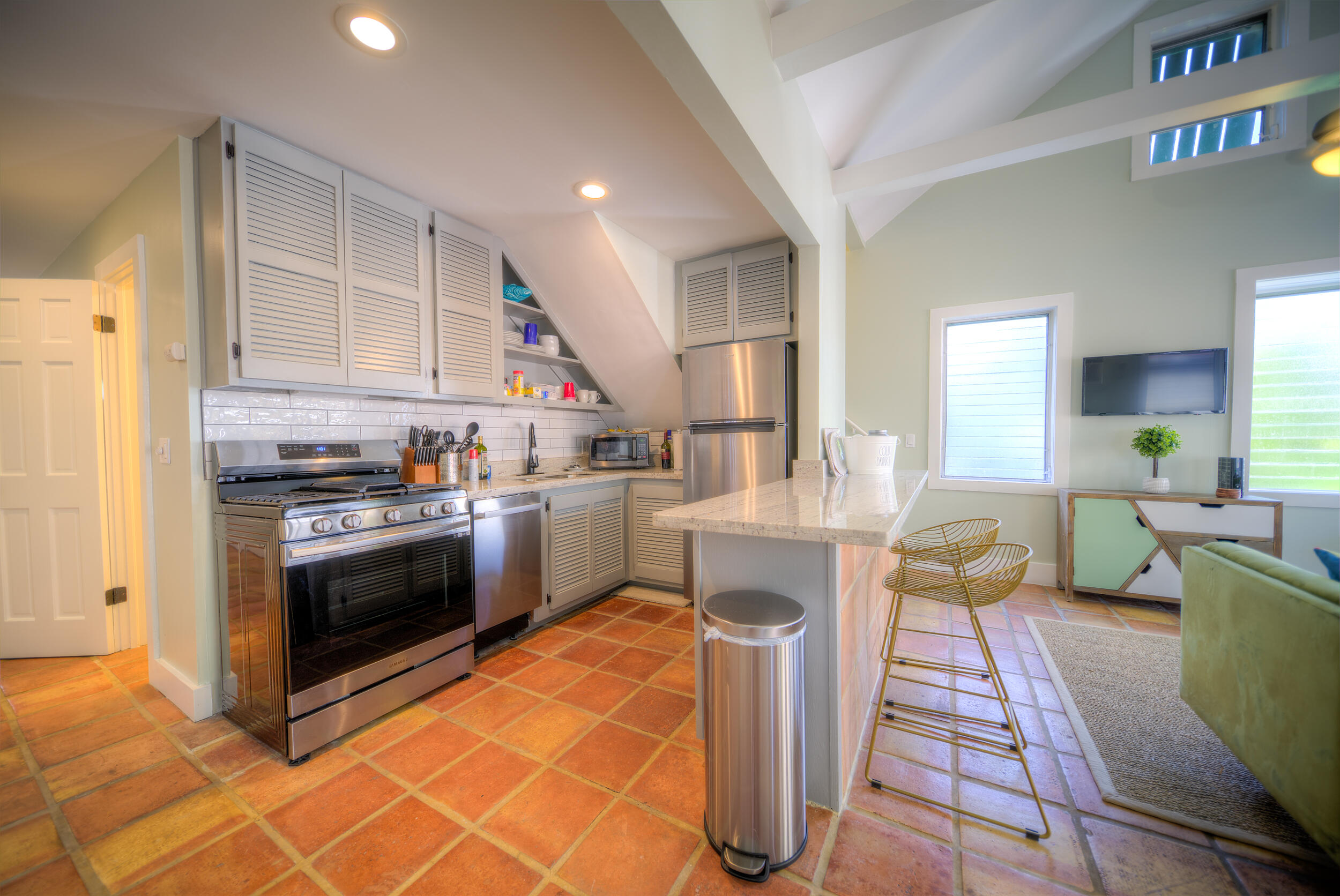 1317 Newton Street Key West, FL 33040 - Photo 5 of 19 a kitchen with stainless steel appliances granite countertop a stove a sink and a microwave