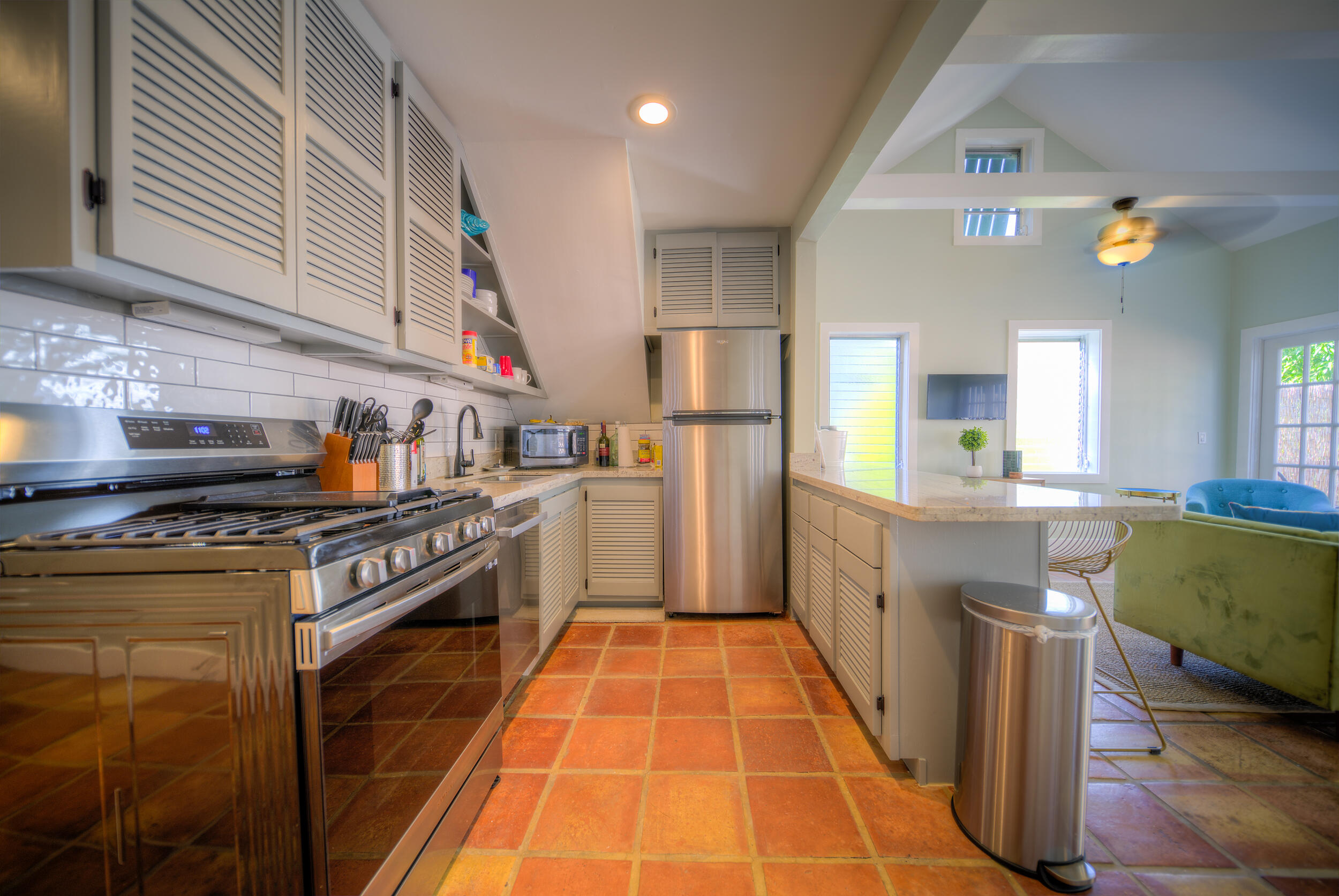 1317 Newton Street Key West, FL 33040 - Photo 6 of 19 a kitchen with stainless steel appliances granite countertop a stove a sink dishwasher and a refrigerator