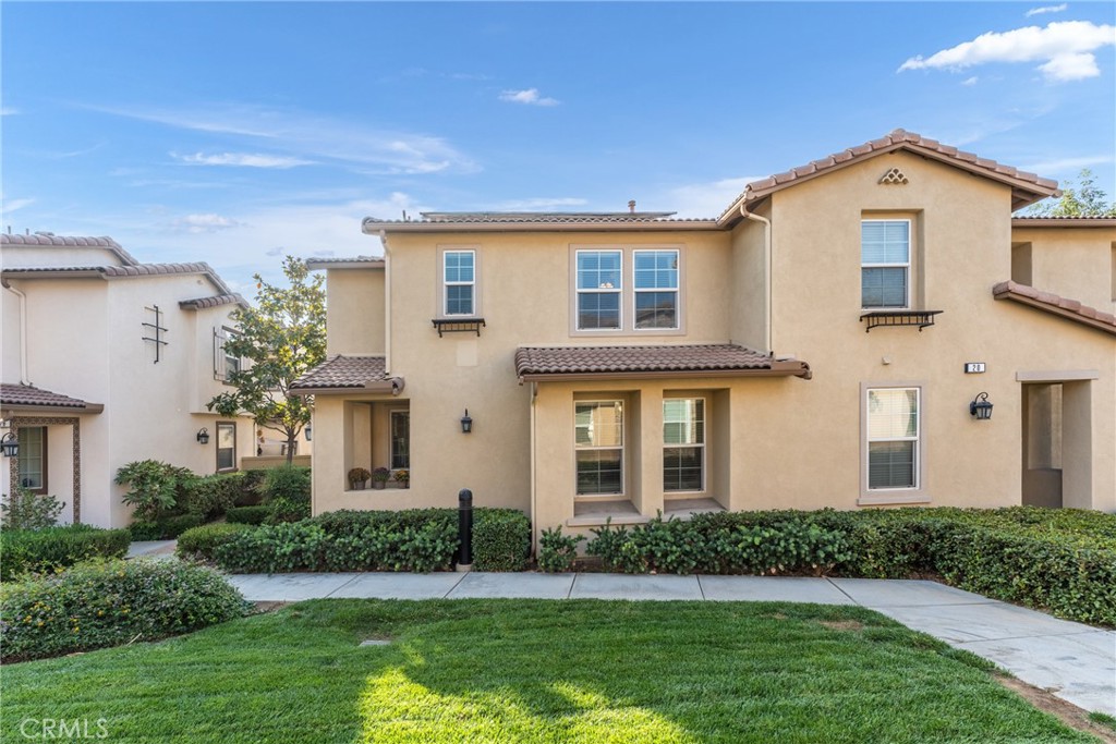 8090 Cornwall Court, Unit 19 Rancho Cucamonga, CA 91739 - Photo 1 of 1 a front view of a house with a yard and garage