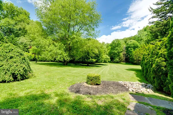 a view of a patio with couches table and chairs and potted plants