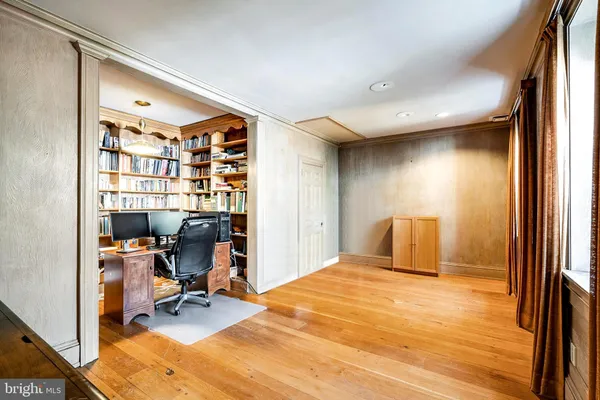 a spacious bedroom with a large bed and wooden floor