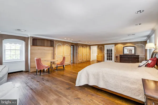 a spacious bedroom with a bed and a view of bedroom