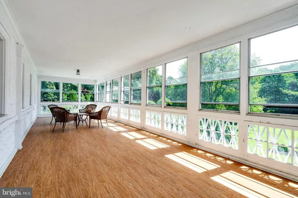 a spacious bedroom with a bed and wooden floor