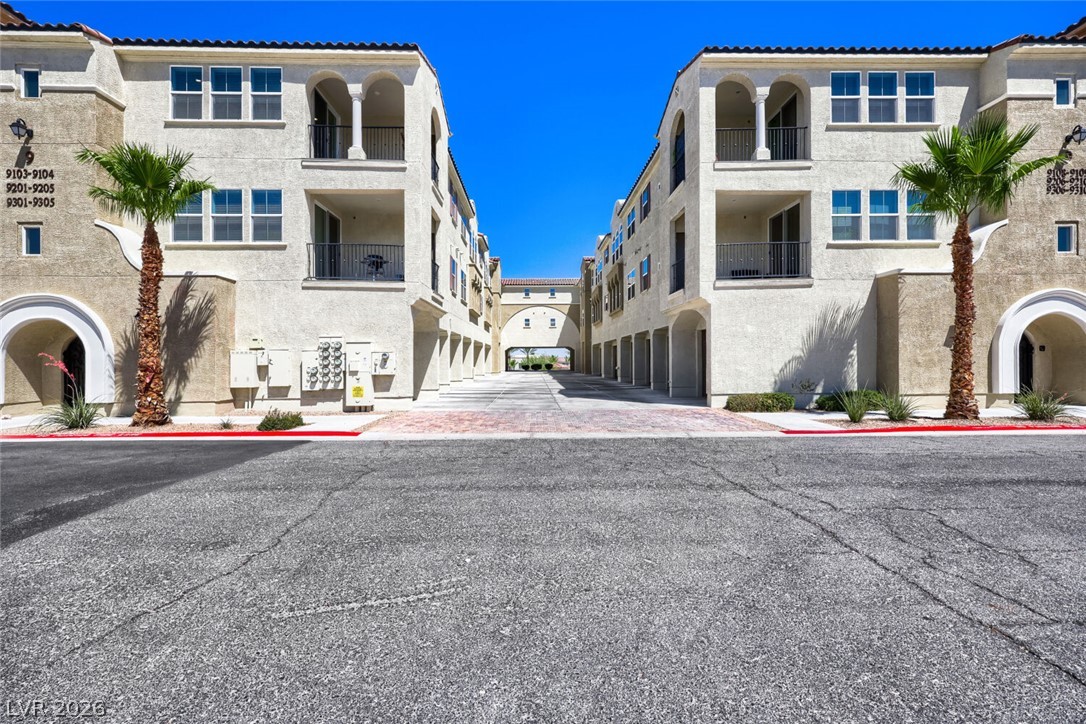 2555 Hampton Road, Unit 9301 Henderson, NV 89052 - Photo 1 of 36 Mediterranean-inspired multi-story buildings flank a paved entry leading to a shared courtyard.