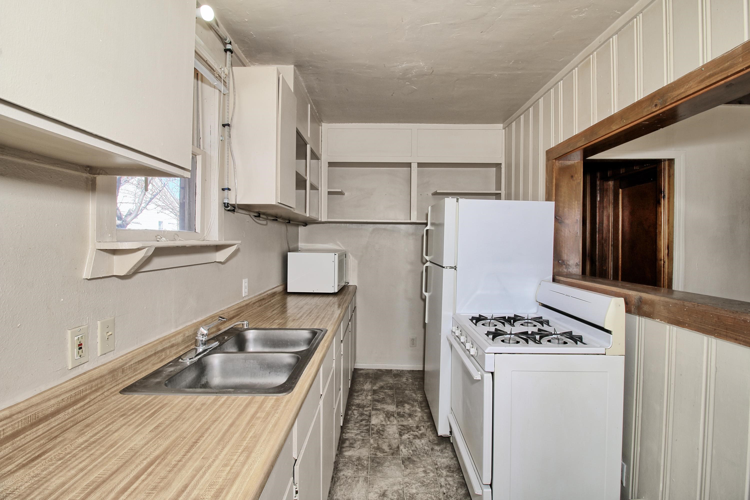 1002 Elm Avenue, Unit B Collbran, CO 81624 - Photo 12 of 17 a kitchen with a stove a refrigerator and a sink