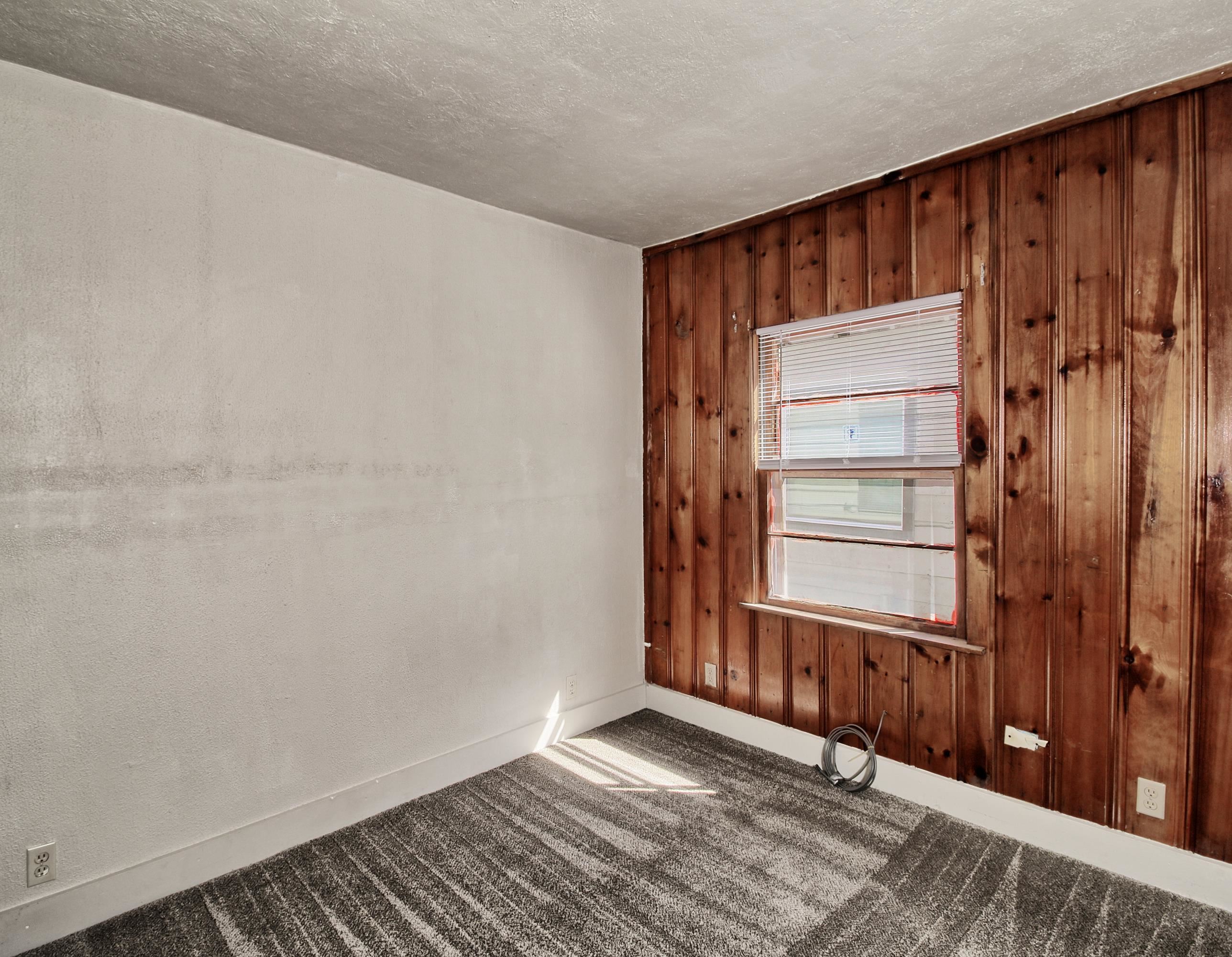 1002 Elm Avenue, Unit B Collbran, CO 81624 - Photo 14 of 17 a view of an empty room with wooden floor and a window