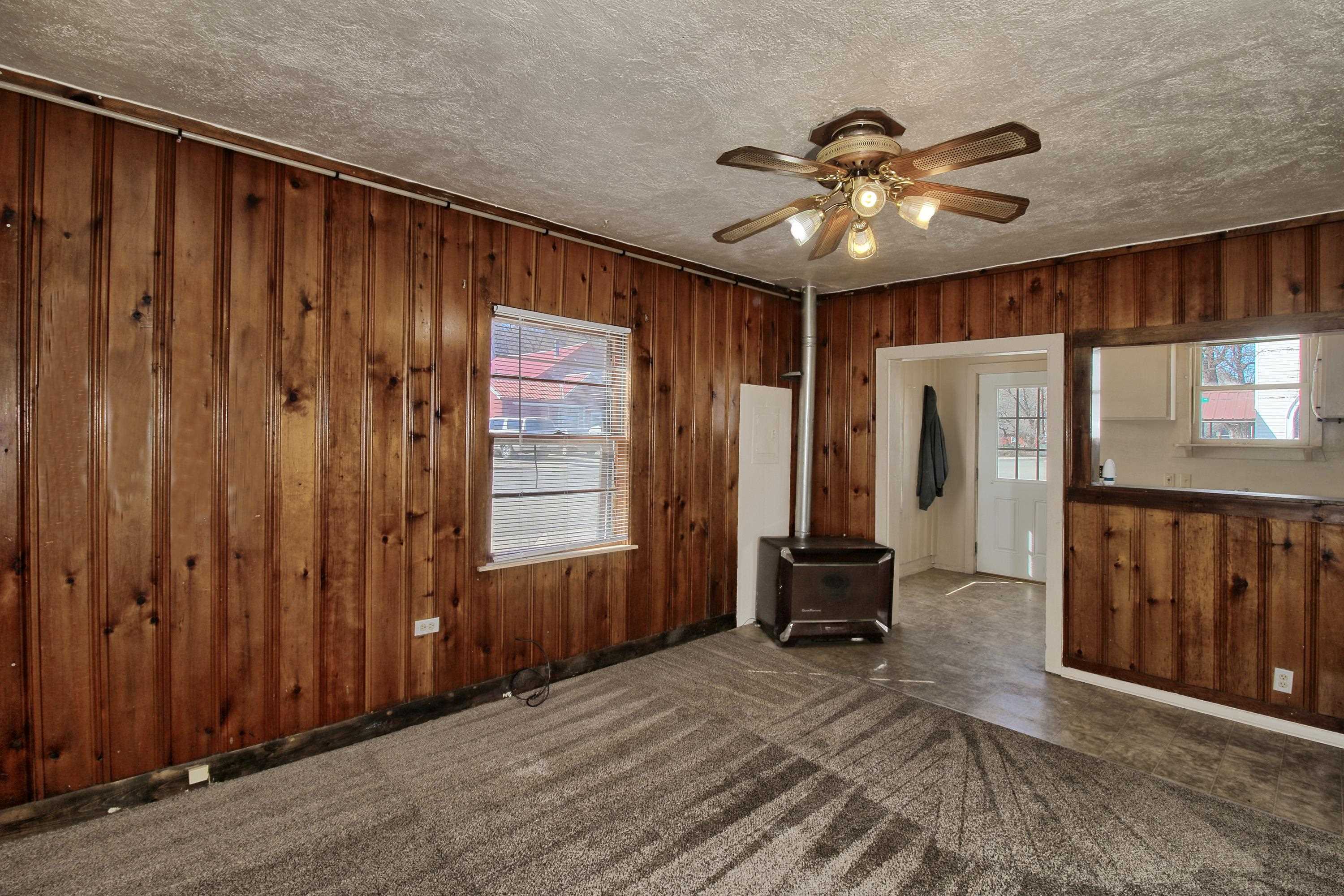 1002 Elm Avenue, Unit B Collbran, CO 81624 - Photo 9 of 17 wooden floor in an empty room with a window