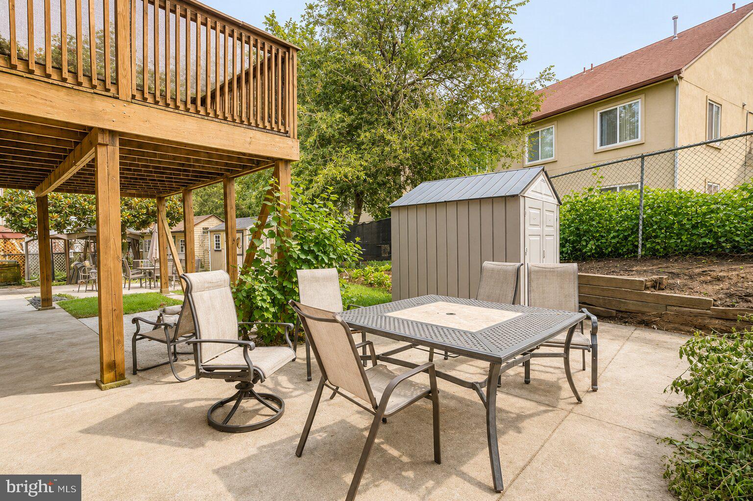 1723 Rachael Street, Unit B Philadelphia, PA 19115 - Photo 3 of 22 a view of a patio with table and chairs with wooden fence