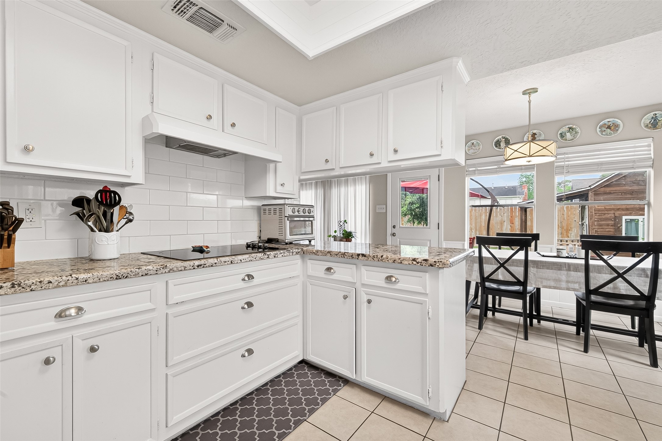 17611 Sorrell Ridge Drive Spring, TX 77388 - Photo 25 of 50 a kitchen with granite countertop white cabinets and white appliances