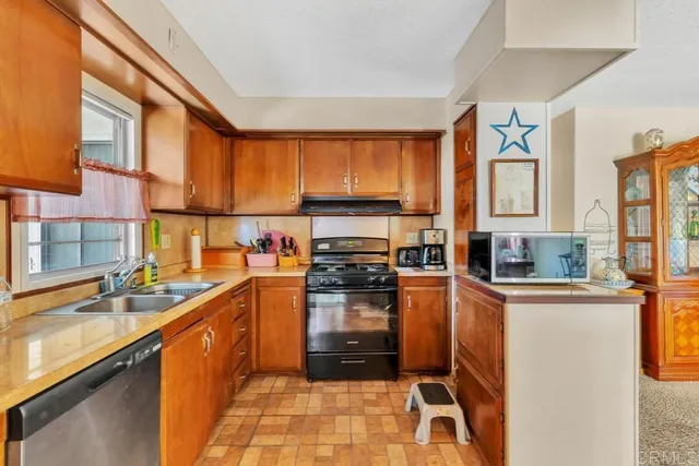 a kitchen with a sink stove and cabinets