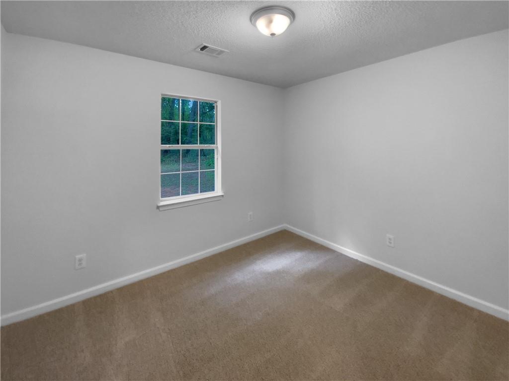 230 Myrtle Grove Lane Covington, GA 30014 - Photo 12 of 19 an empty room with a window