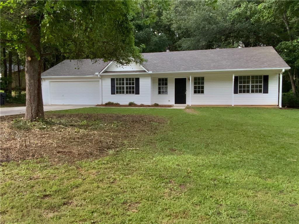 230 Myrtle Grove Lane Covington, GA 30014 - Photo 2 of 19 a front view of a house with a garden