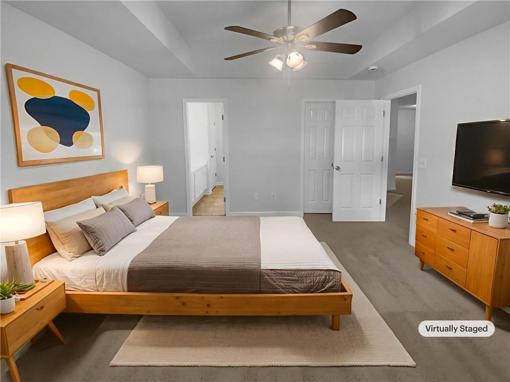 230 Myrtle Grove Lane Covington, GA 30014 - Photo 8 of 19 a bedroom with a bed and a flat screen tv