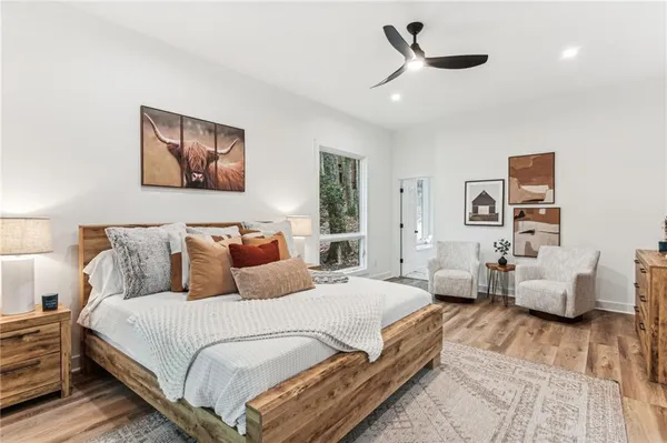 a room with furniture pool table wooden floor and a rug