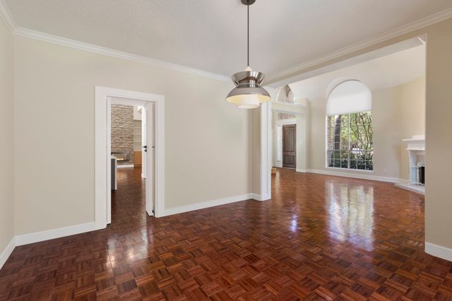 a living room with furniture and a view of kitchen