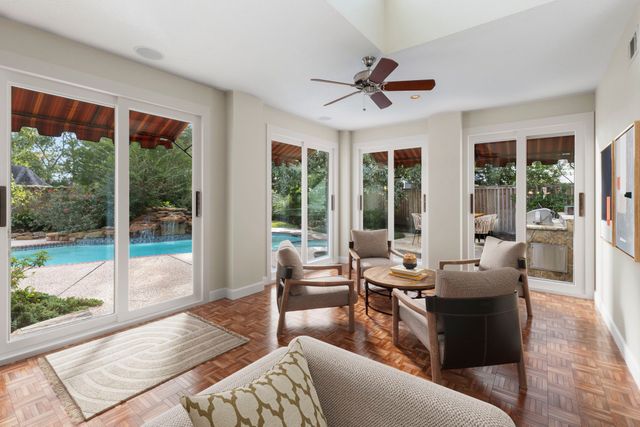 a living room with furniture and a view of kitchen