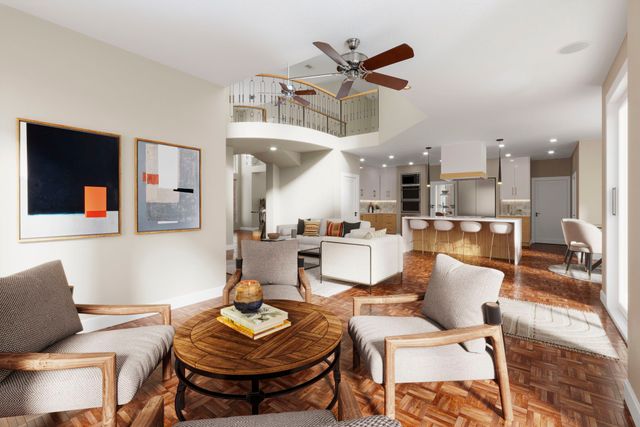 a kitchen with stainless steel appliances kitchen island granite countertop a refrigerator a stove a sink and a dining table with wooden floor