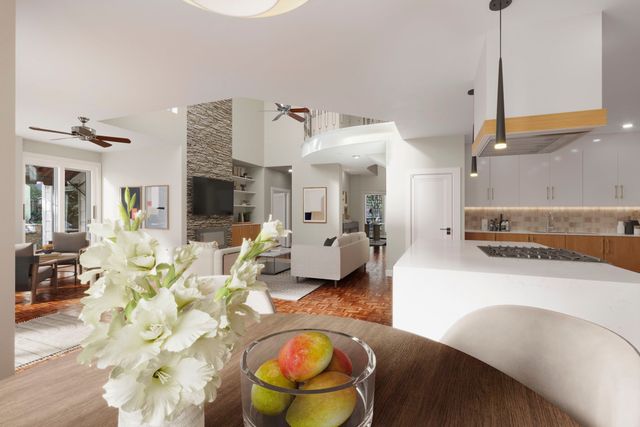 a kitchen with stainless steel appliances kitchen island granite countertop a refrigerator a stove and a sink