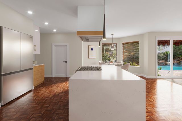 a kitchen with cabinets appliances a sink and a counter top space