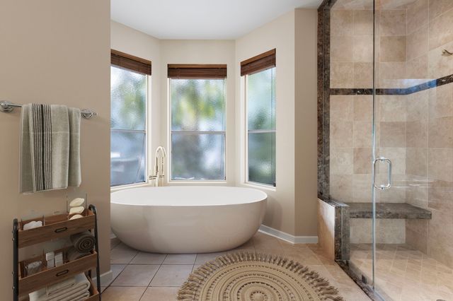 a kitchen with stainless steel appliances kitchen island granite countertop a refrigerator and a sink