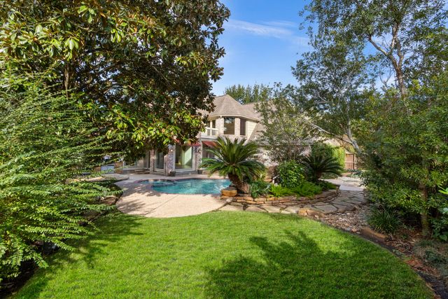 an empty room with large windows and a fireplace