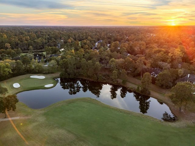 a kitchen with stainless steel appliances granite countertop stove a sink a refrigerator and a wooden cabinets