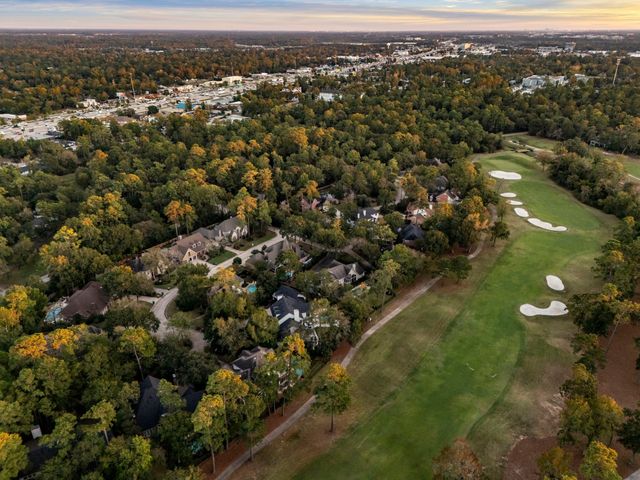 an empty room with chandelier fan and windows