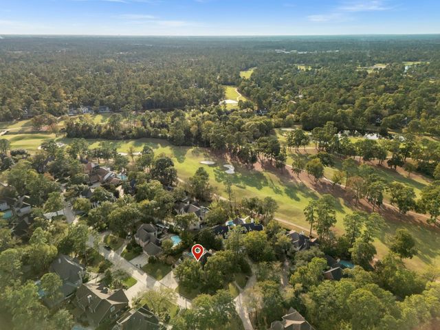 a view of a hallway with furniture and a fireplace