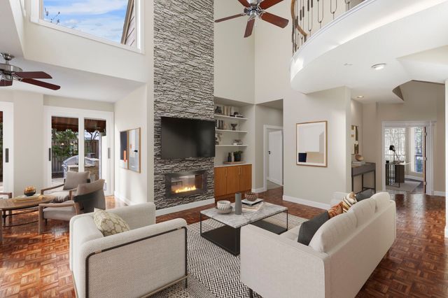 a living room with furniture fireplace and window