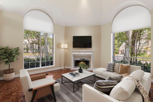 a living room with furniture fireplace and flat screen tv