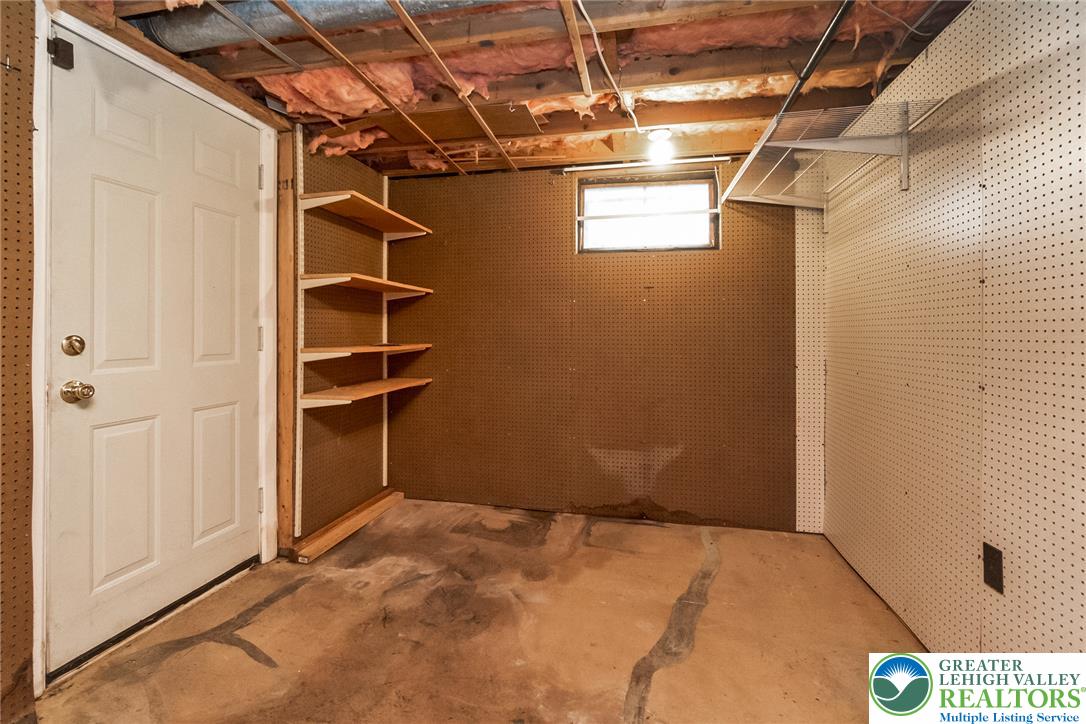 268 Apollo Drive Bethlehem, PA 18017 - Photo 43 of 56 A utilitarian basement space offers practical storage solutions with shelving.